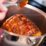 Maple-Balsamic-Ginger-glazed-Ham-spooning-on-glaze-Dinner-4-Two